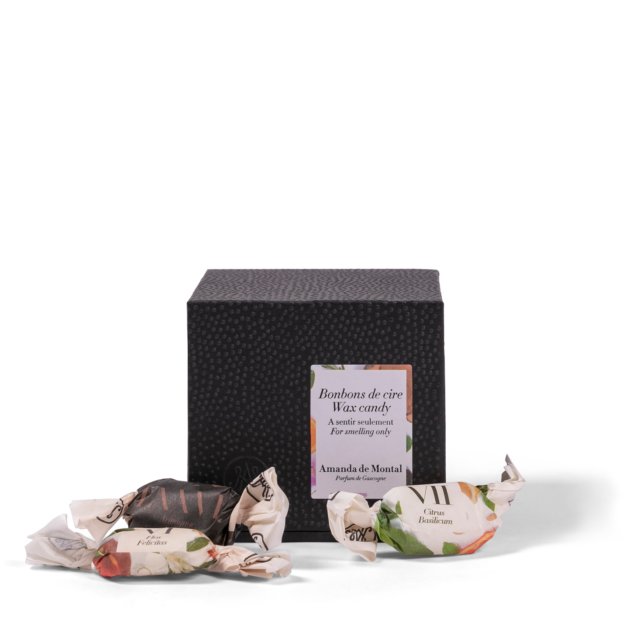 A small, elegant black box containing a variety of perfumed wax candies. Each scented wax candy is crafted from natural, plant-based waxes, precisely blended to release delightful aromas.
