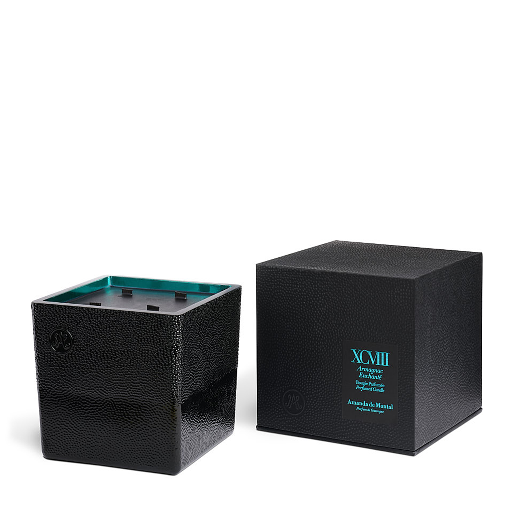 An artisanal black glass vessel, mouth-blown by master glassmakers, with thousands of bubbles and an amber mirror interior reflecting the twinkling light of the burning wick. Contains fragrances of cypress, pine needles, and moss, with a drop of 20-year-old Armagnac, creating a beautiful woody yet fresh scent.