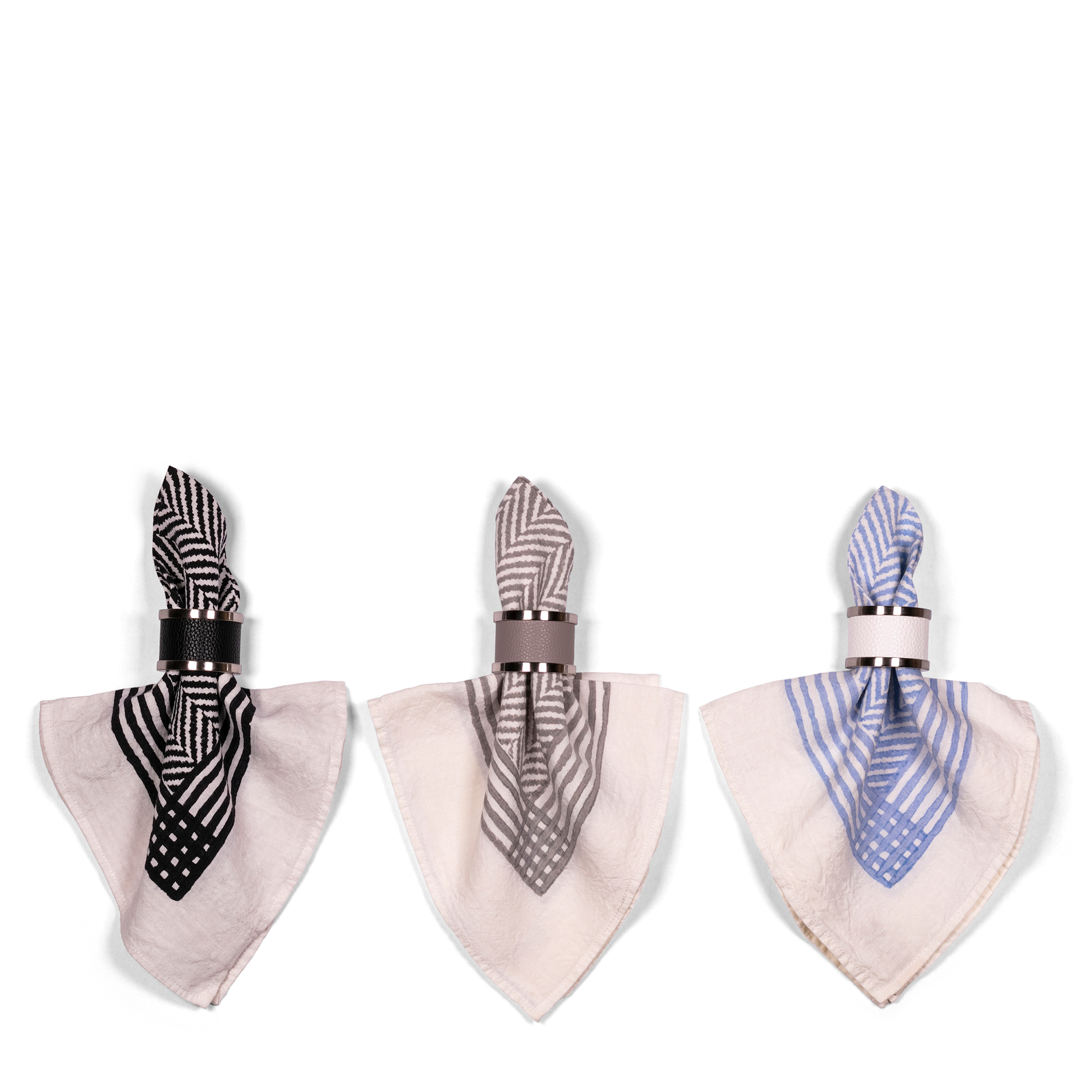 This elegant combination of napkins featuring black, grey, and blue chevron patterns with black, taupe, and white napkin rings elevates your table, and brings a modern design and practicality to your dining experience.