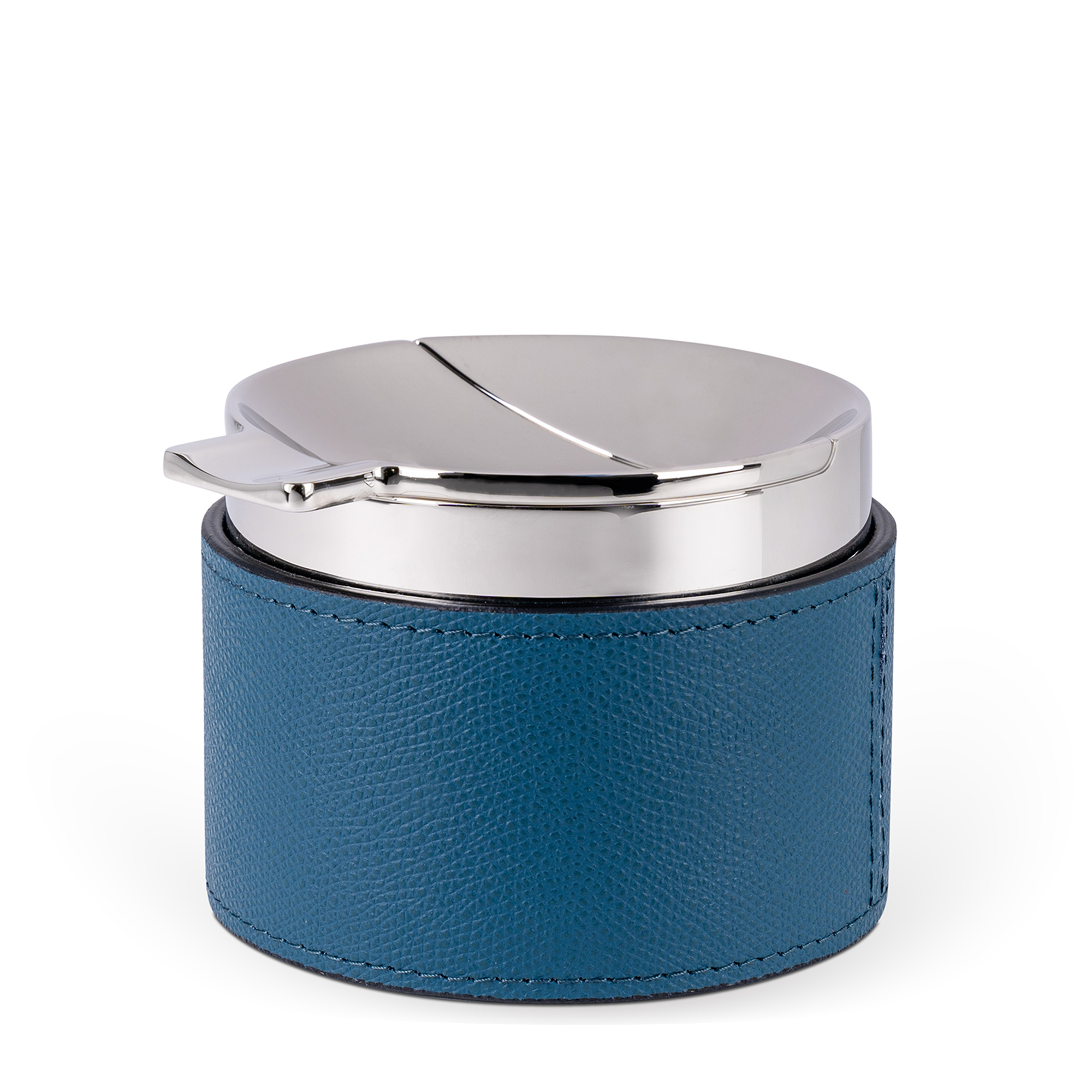 This sleek, cylindrical ashtray features a petrol blue embossed leather base and a removable chrome-plated center chamber. Windproof and easy to clean, it also includes a cigar holder.