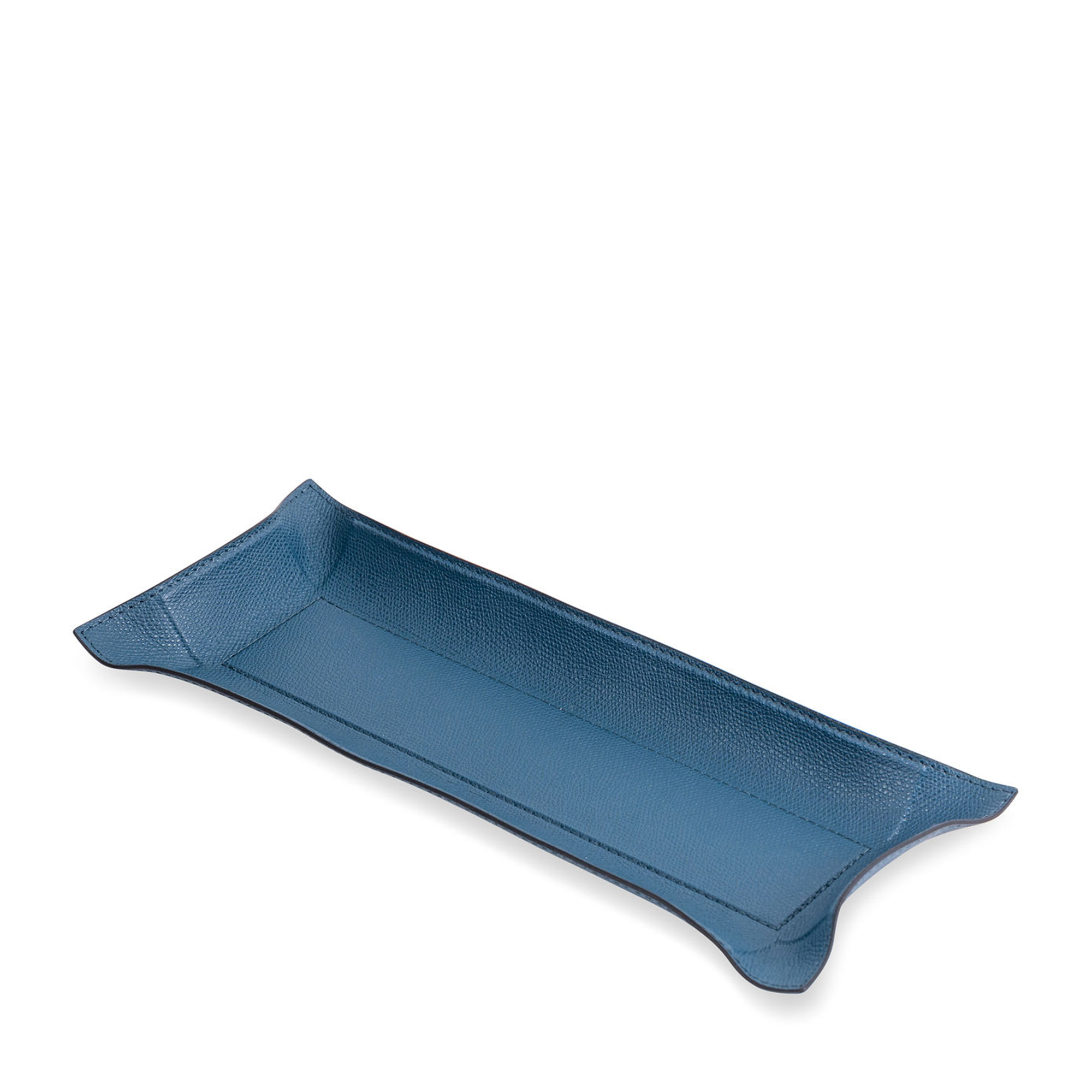 This rectangular petrol blue tray with black borders has the hard base and flexible sides that can be adapted to your preferred arrangement. Covered in the finest calfskin, it makes a both functional and decorative piece for any space at home.