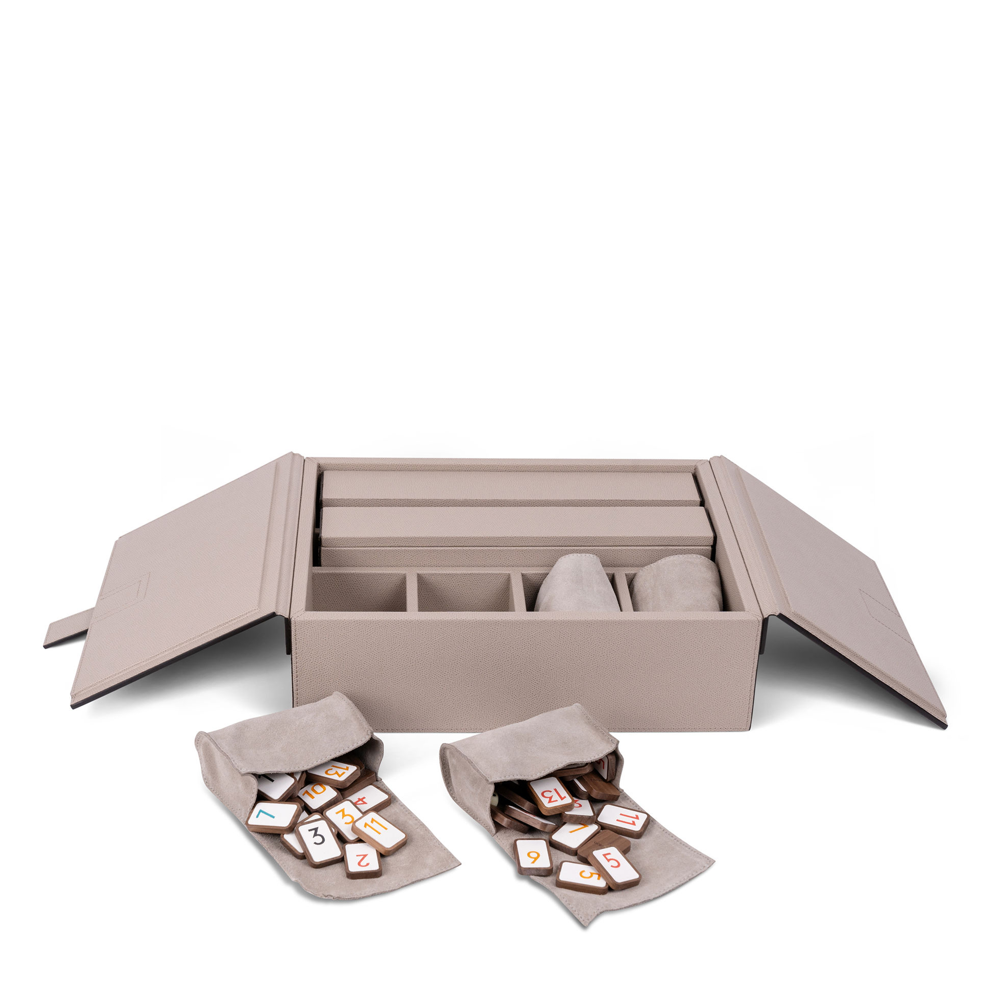 Encased in an elegant wooden box covered in dove gray leather, this game set includes four Rummikub racks and walnut tiles with white nappa leather inserts and bold-printed numbers. The tiles are organized by color in four soft suede pouches.