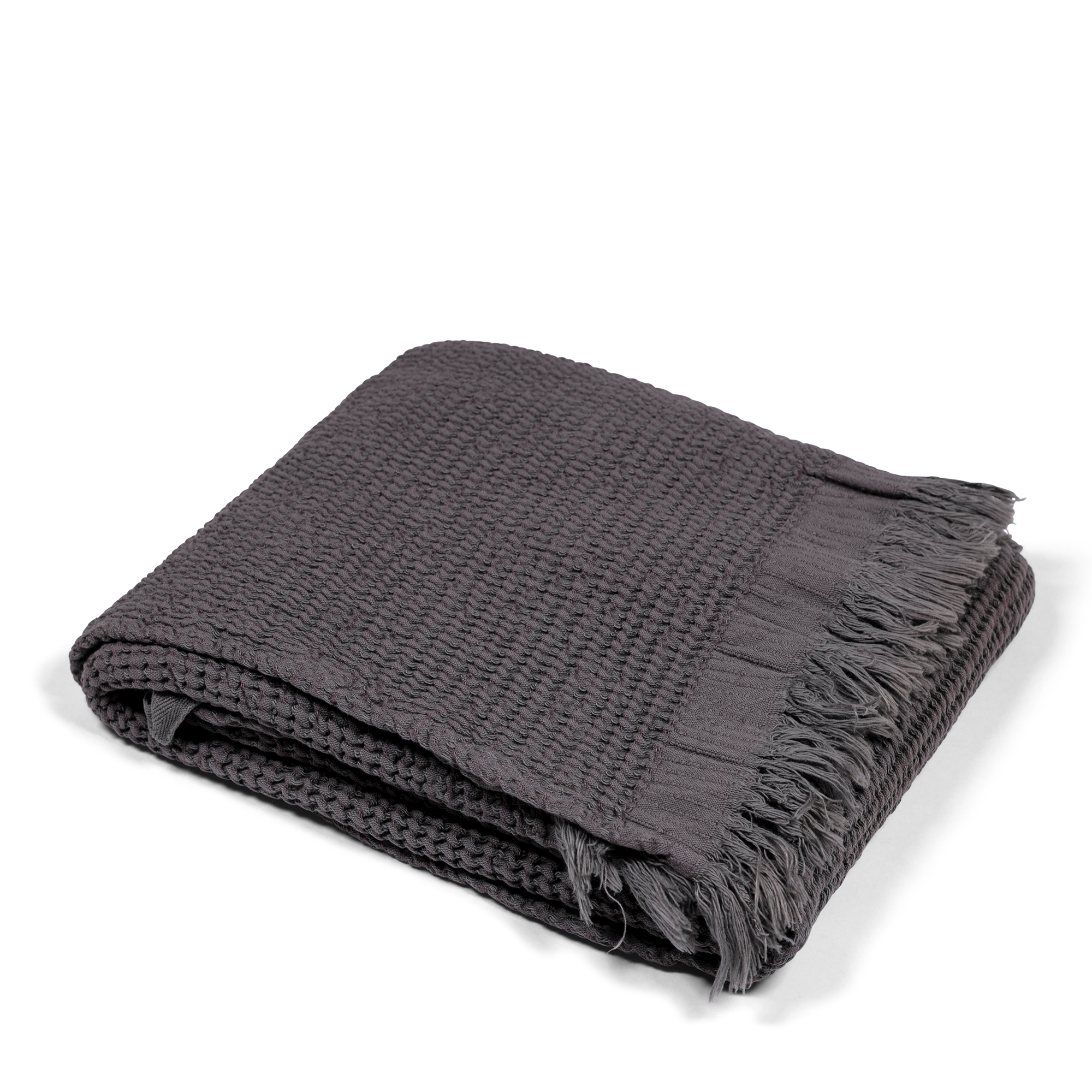 This dark grey Turkish bath towel offers excellent absorbency and quick drying. Waffle weave, made from 80% cotton and 20% bamboo, it's organic, sustainable, and exceptionally soft.