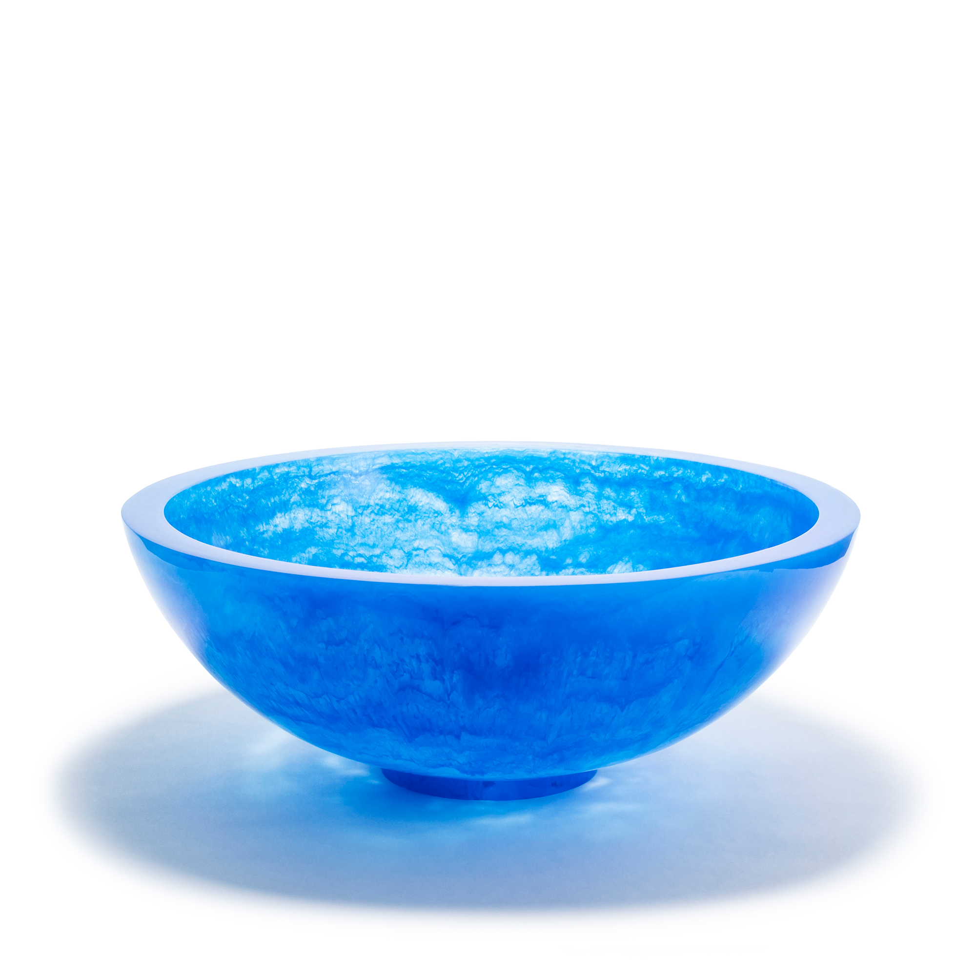 A vibrant deep blue bowl with a smooth, glossy surface and an ethereal, cloud-like texture within the resin material, creating a captivating visual effect. The bowl has a rounded shape with a slightly elevated base, giving it a floating appearance.