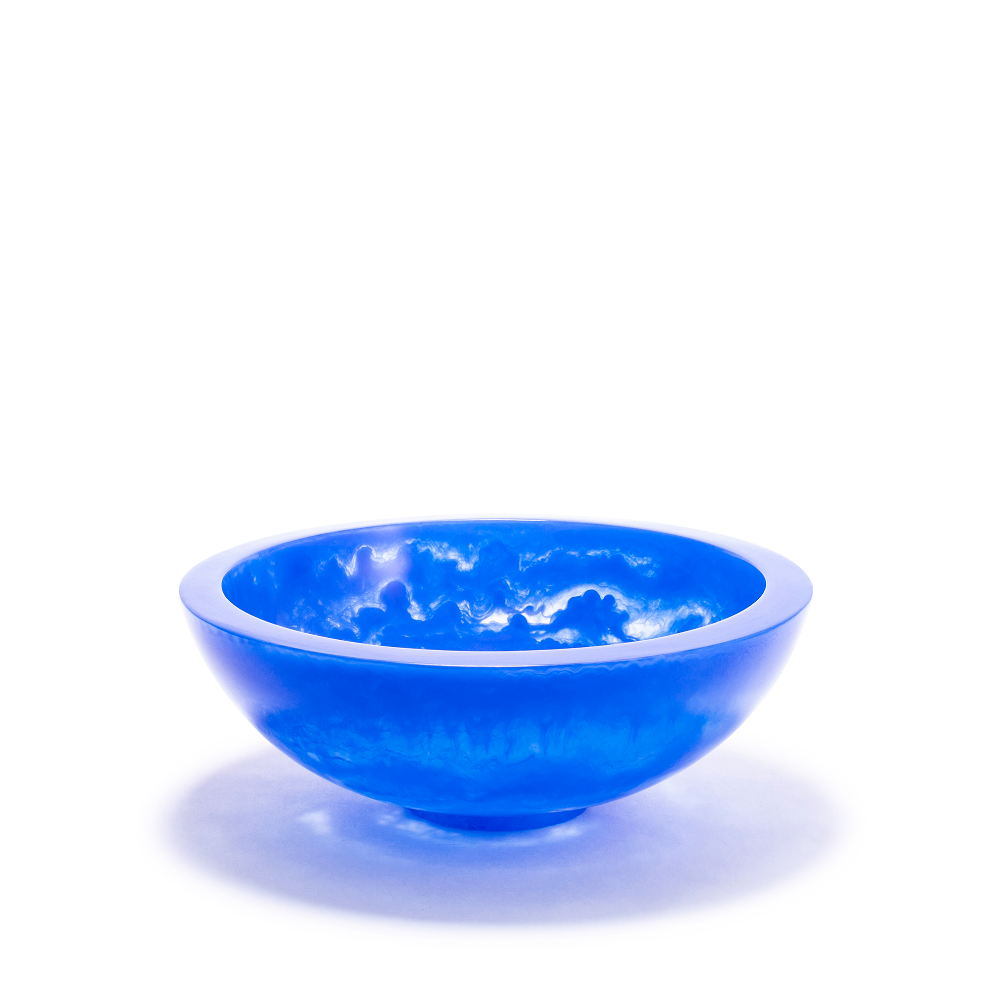A vibrant deep blue smaller bowl with a smooth, glossy surface and an ethereal, cloud-like texture within the resin material, creating a captivating visual effect. The bowl has a rounded shape with a slightly elevated base.