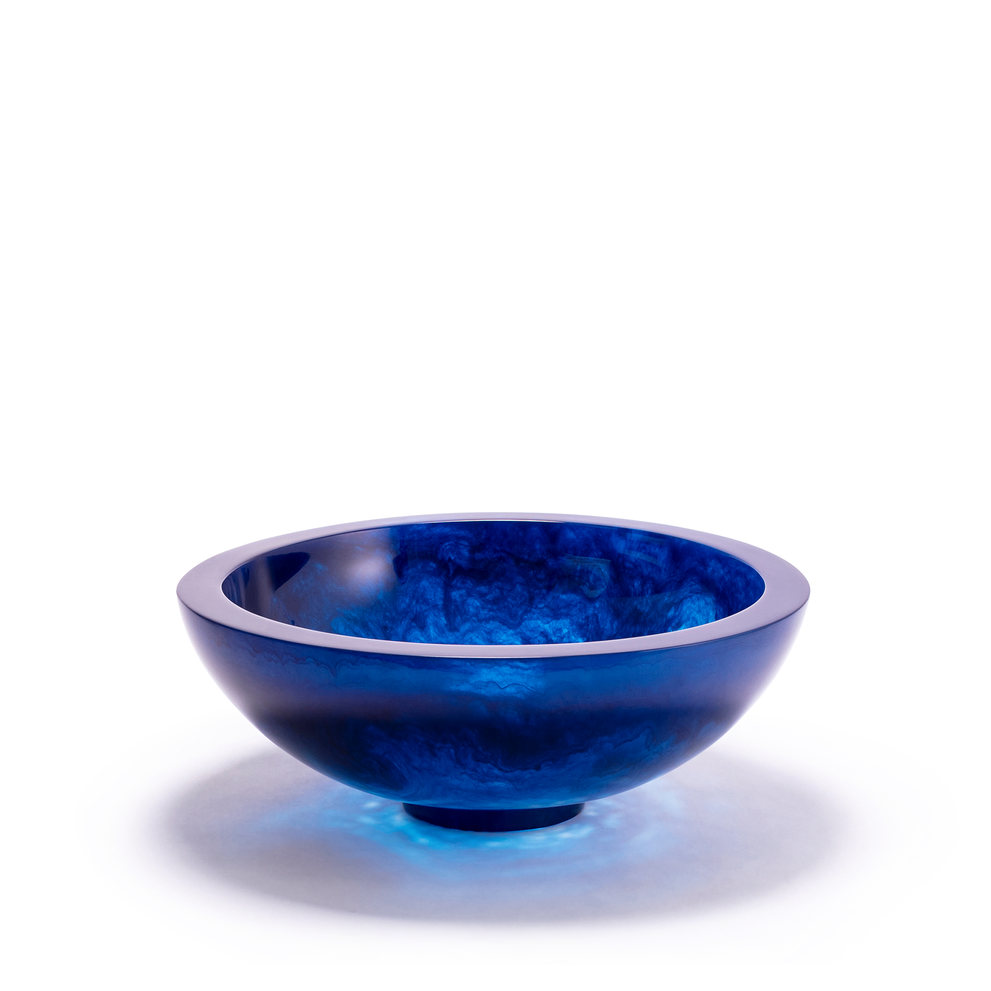 Navy blue bowl with a smooth, glossy surface and an ethereal, cloud-like texture within the resin material, creating a captivating visual effect. The bowl has a rounded shape with a slightly elevated base.