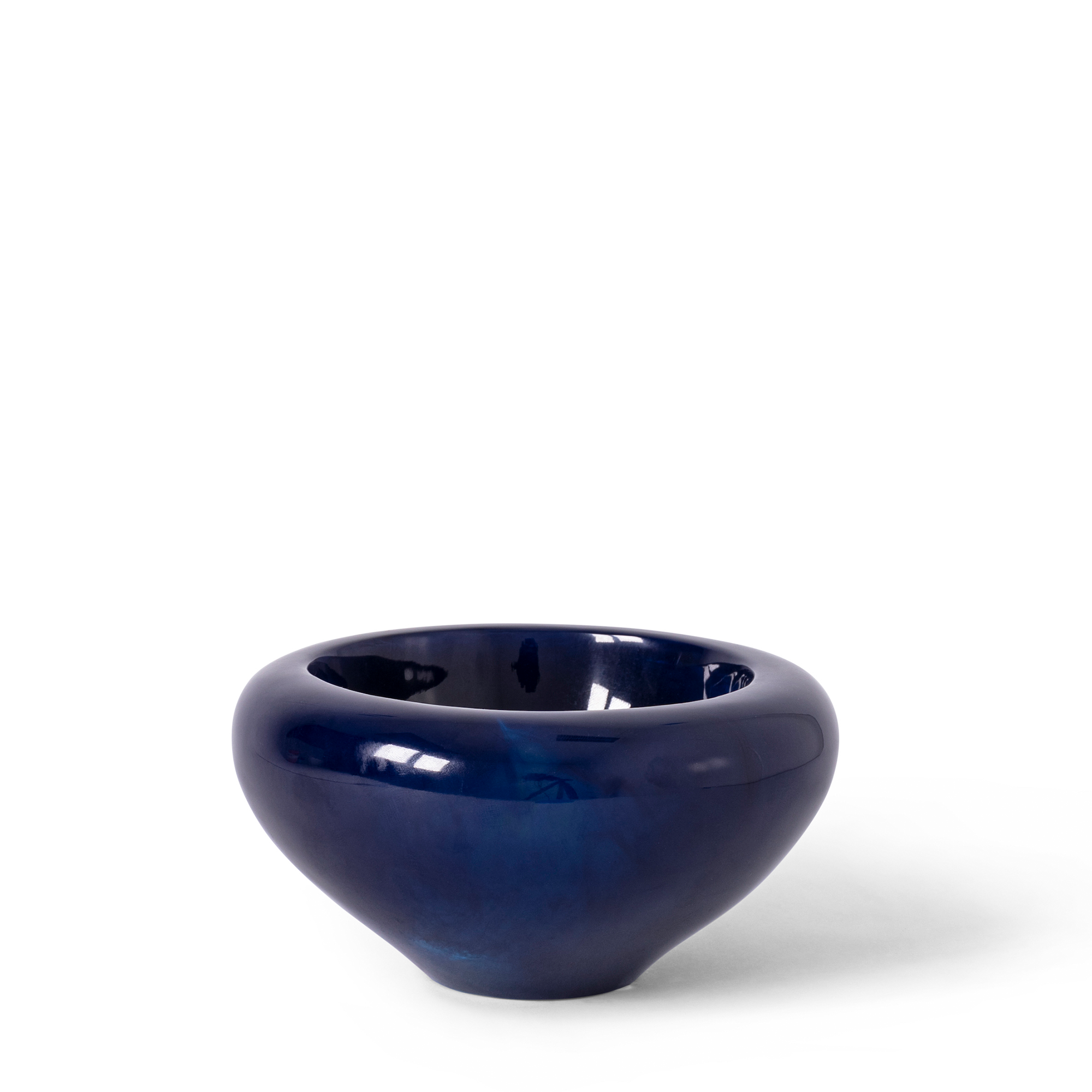 A deep navy spice bowl with a smooth, polished exterior and a delicately marbled interior that subtly catches the light. The bowl features a rounded, modern design with a slightly elevated base.