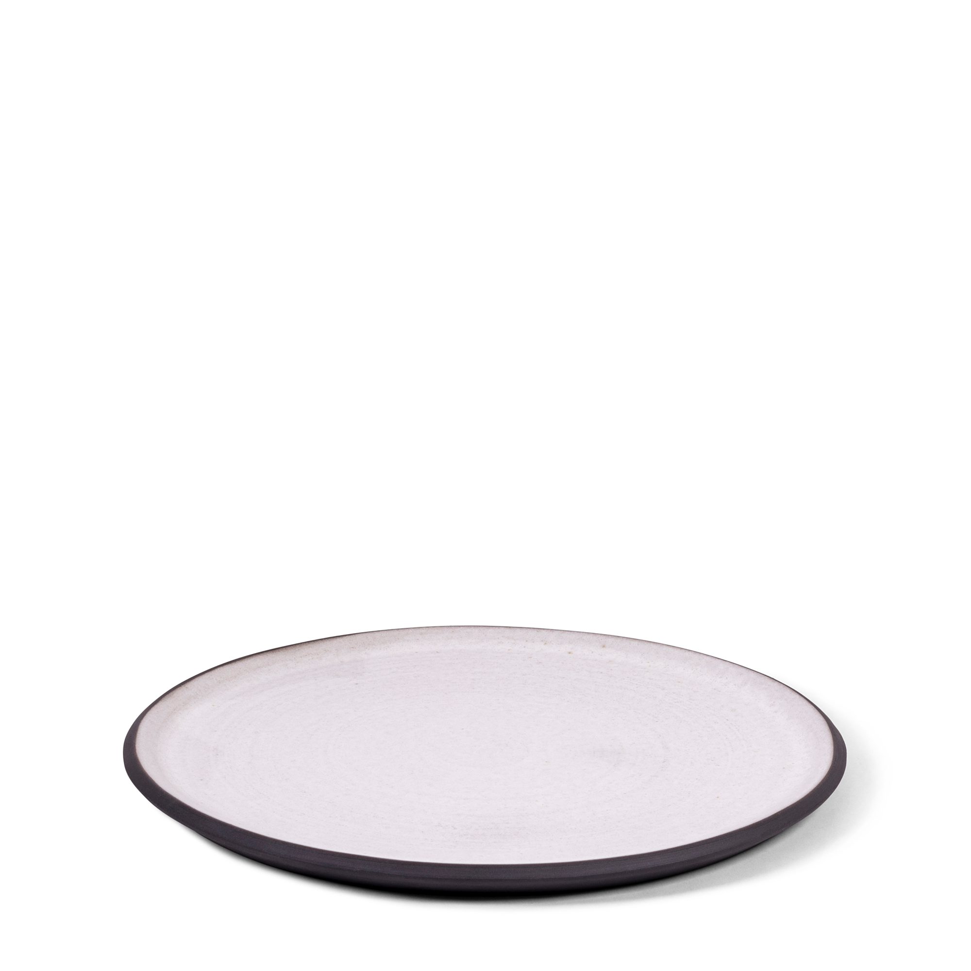 Handmade classic dinner plate blending raw blackware with a soft white glaze. This artisanal piece features slight natural variations that enhance its unique beauty and elegance for your table.
