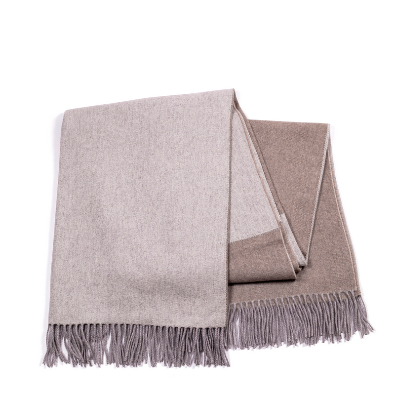 This reversible throw offers flexibility and allows you to switch between the two complementary colors to match your decor. Light brown and a soothing grey shade add comfort and warmth to your living space.