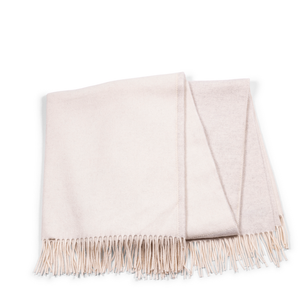 This cashmere throw fits into every home interior, giving a creamy ivory hue and soft light grey on the reverse, and making every room cozy and stylish.