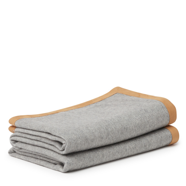 Luxurious and soft grey throw, made of cashmere with exquisite suede edges.