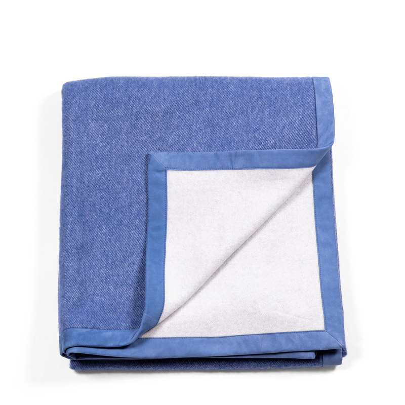 Luxurious and soft blue throw, made of cashmere, with exquisite blue suede edges.