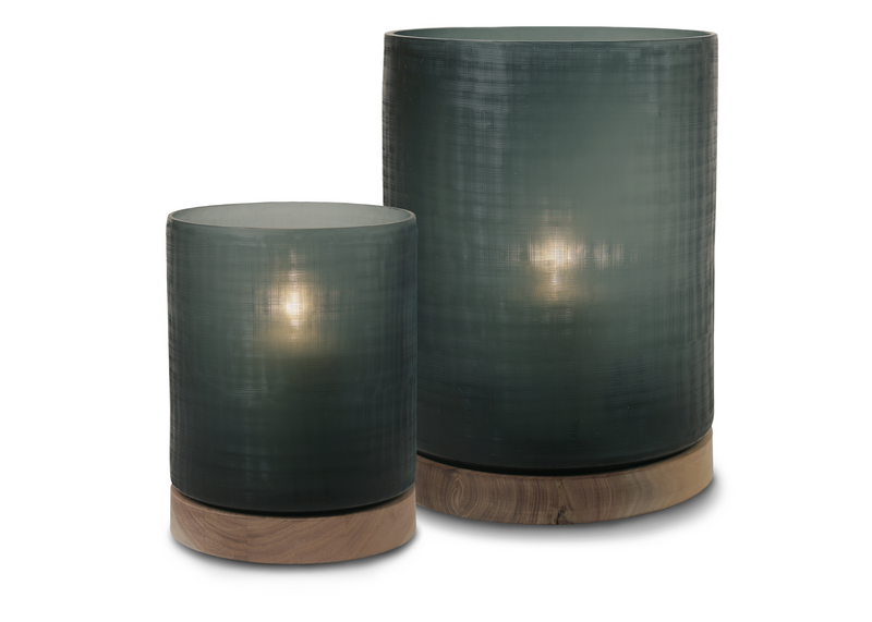 This elegant Aran Hurricane, made of glass and sycamore wood, captures attention with its simplicity and brings warm atmosphere into any indoor and outdoor space, casting soothing darker green shadows.