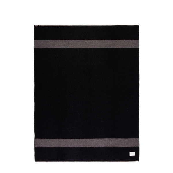This versatile throw shows a bold design with dark grey stripes against a sleek black backdrop. Its reversible feature offers you the flexibility to switch up your decor effortlessly. Crafted for both warmth and visual appeal, this throw is the perfect addition to cozy evenings and stylish living spaces.