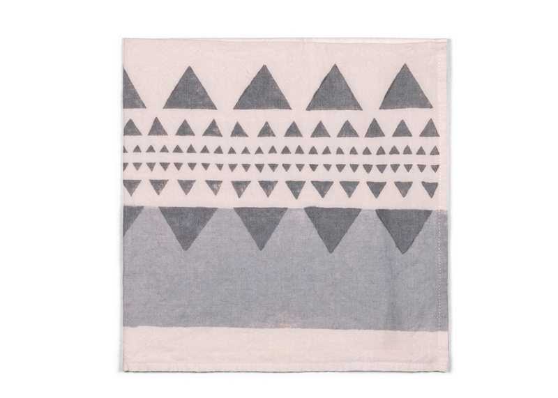 This napkin reveals a modern geometric pattern in shades of grey, accented with subtle touch of silver.