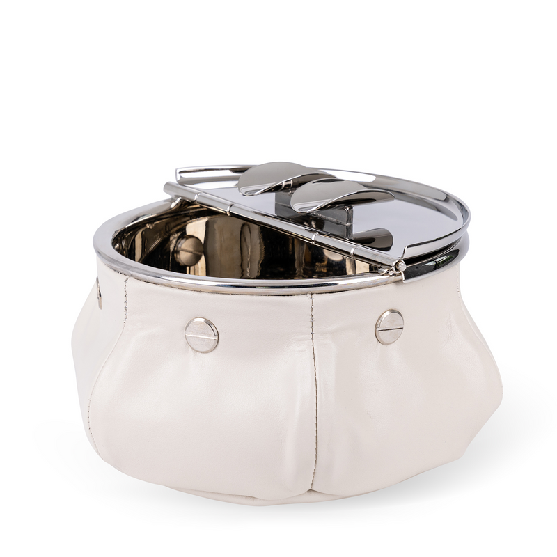 This windproof ashtray features a metal container that collects ashes, a metal lid containing the ashes, and cigar (or cigarette) holders underneath. Luxuriously covered in off-white nappa leather, it makes a functional and decorative piece for any space.