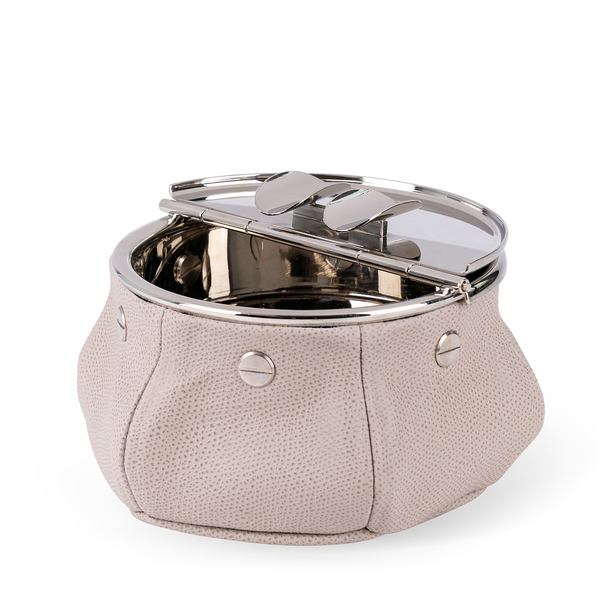 This windproof ashtray features a metal container that collects ashes, a metal lid containing the ashes, and cigar (or cigarette) holders underneath. Luxuriously covered in stone beige leather, it makes a functional and decorative piece for any space.