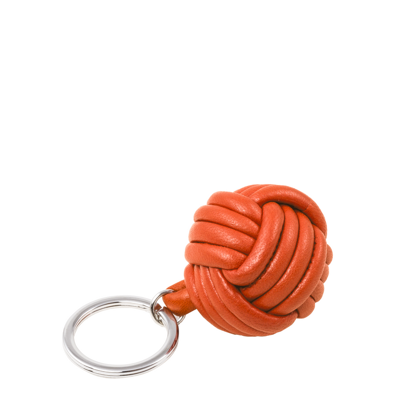 Handcrafted from exquisite nappa orange leather by skilled artisans, it adds a vibrant elegance to your keyring.