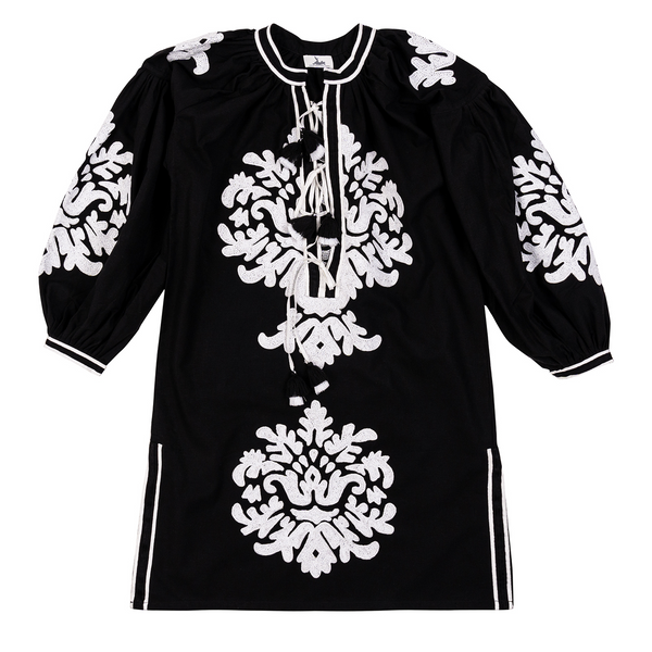This black dress with a hand-embroidered motif, made from 100% linen in Morocco and complemented by white striped trim and a tiered tassel, reflects timeless elegance and makes a statement piece for an evening out or casual day look.