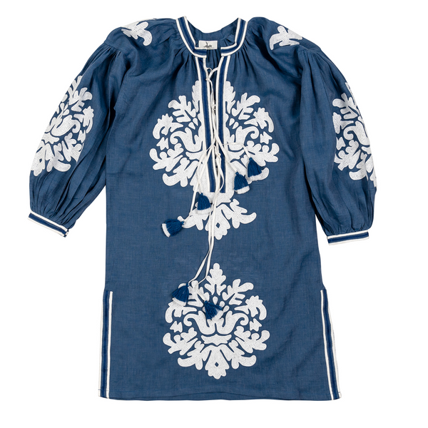 This blue dress with a hand-embroidered motif, made from 100% linen in Morocco and complemented by white striped trim and a tiered tassel, reflects timeless elegance and makes a statement piece for an evening out or casual day look.