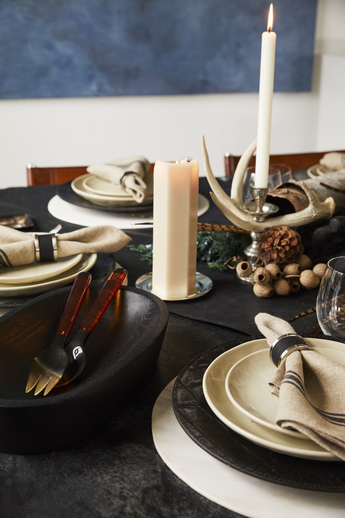 Autumn table with taper candle, antlers and napkin rings