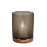 This elegant Aran Hurricane, made of glass + sycamore wood, captures attention with its simplicity and brings warm atmosphere into any indoor and outdoor space, casting smoke grey shadows.
