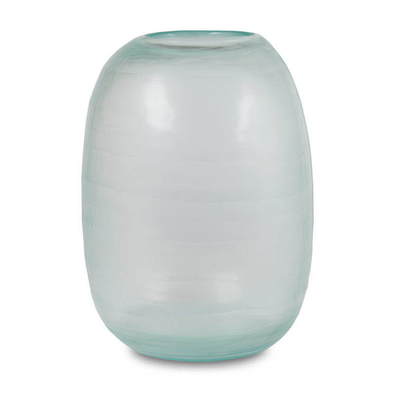Reminiscent of a clear day's sky, this biggest in the collection, handmade glass vase boasts a gentle light blue hue and a curved form that interacts with light across its textured surface, imbuing any space in your home with a touch of elegance.