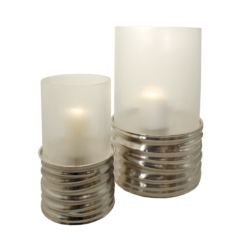 Crafted from mouth-blown glass and accented with asymmetrically pleated metal, this hurricane design exudes style and sophistication. Its composition plays with light, casts soft shadows, and creates a warm atmosphere.