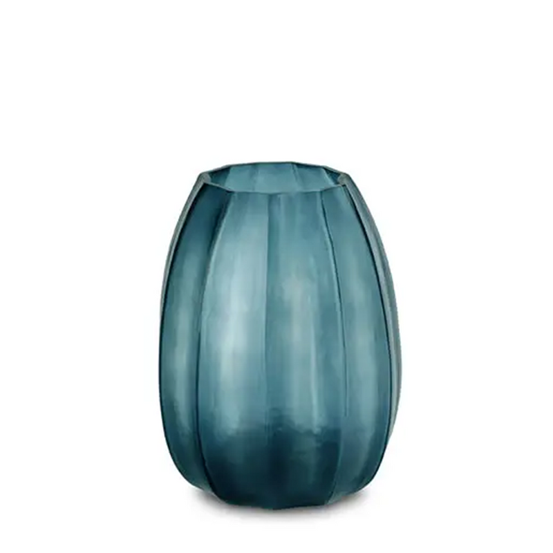 Koonam Vase Medium is made of glass, and has a special, distinctive ridged motif. Its indigo hue and striking faceted, round form makes it a bold, luxurious addition to your home decor.