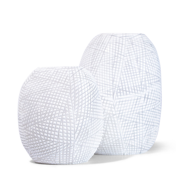 The Patara Vase boasts an alluring hatch pattern on its surface, bringing a captivating texture and opalescent light into your home.