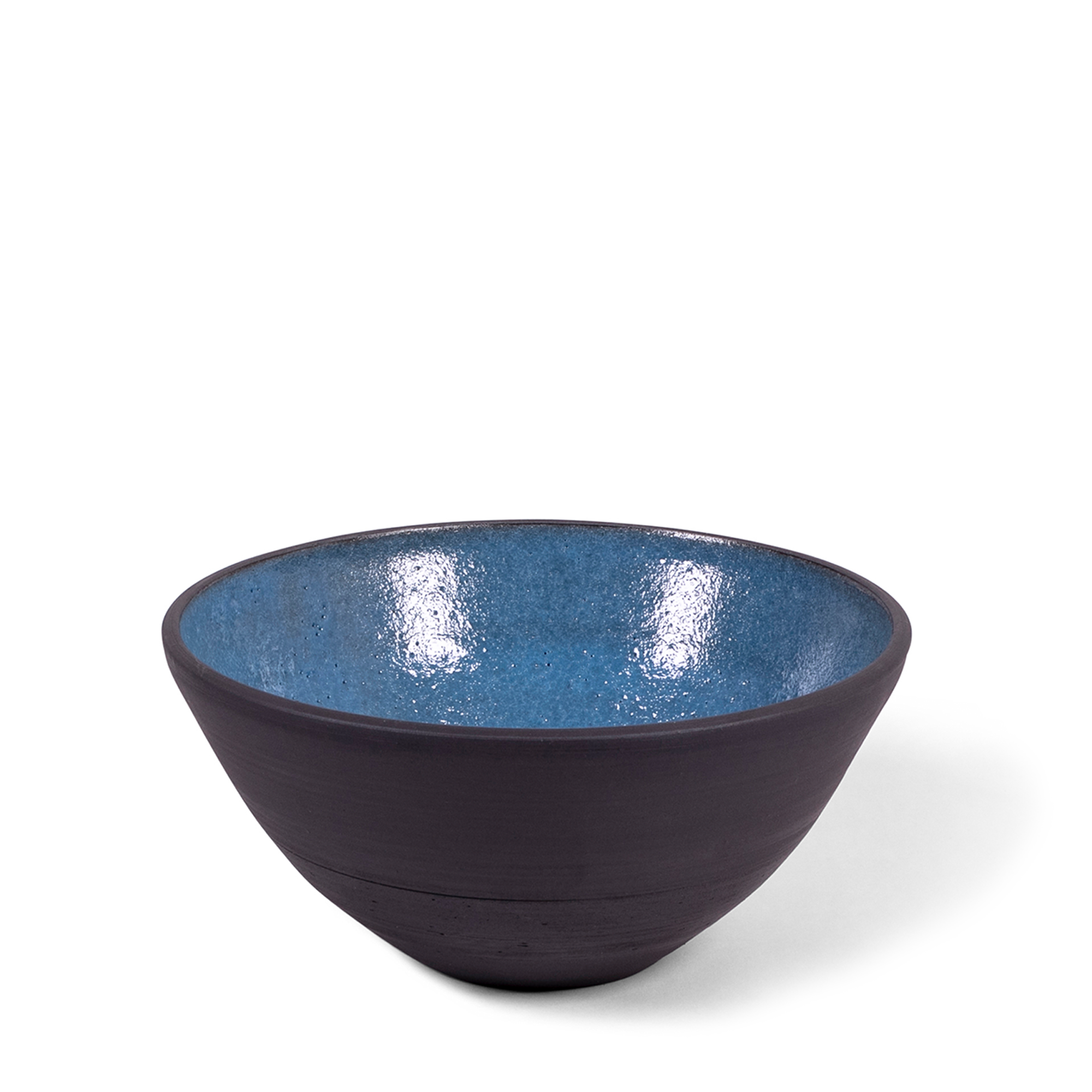 Handmade classic bowl combining raw blackware with delft blue glaze. The piece features slight natural variations, adding to its unique beauty and elegance for your table.