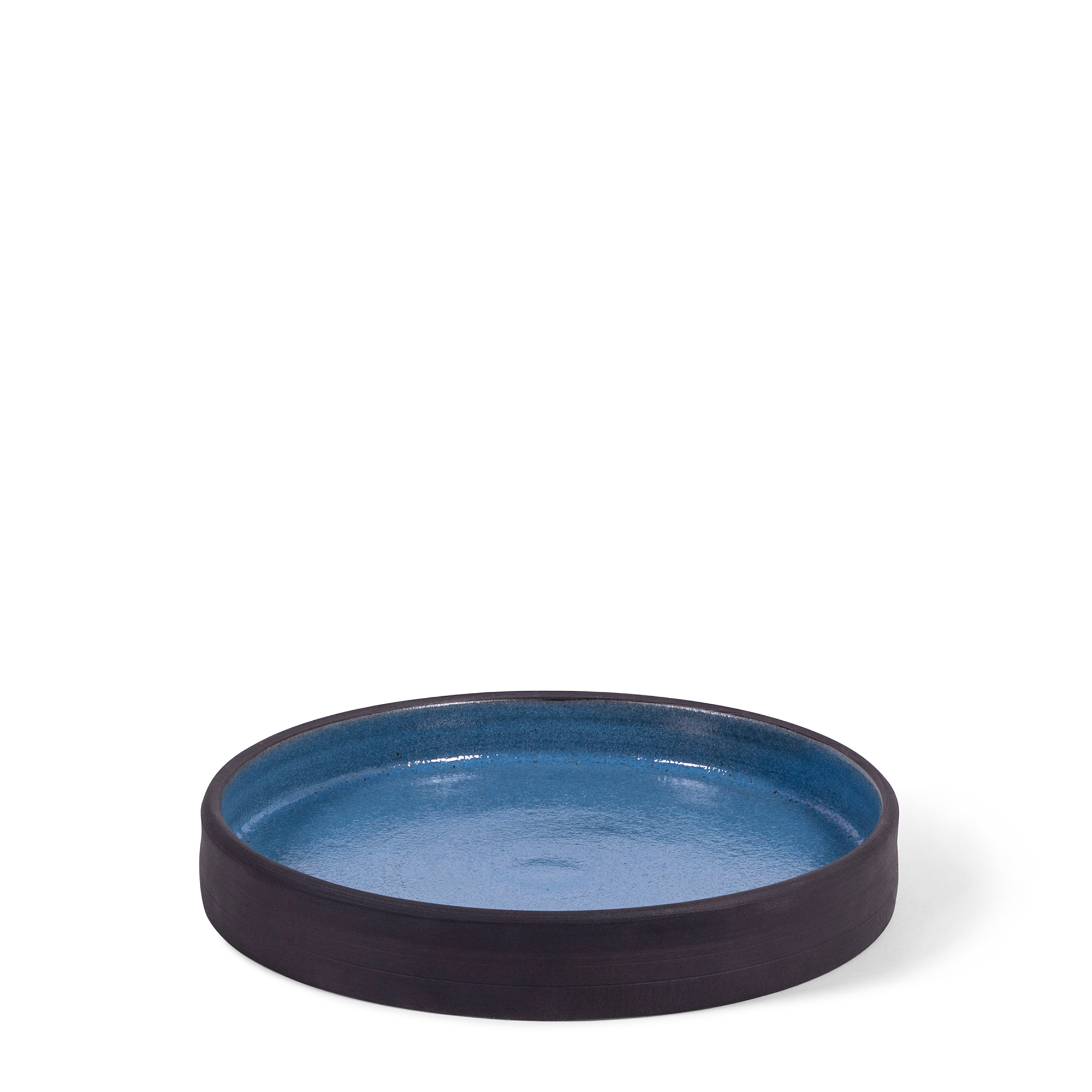 Hand-thrown salad plate with a high-lipped edge, blending raw blackware with a soft delft blue glaze, bringing a rugged yet refined look to your table.