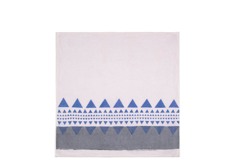 Unfolded Geo Napkin revealing a bigger part of a white side, adorned with grey and blue geometrical details in the bottom.