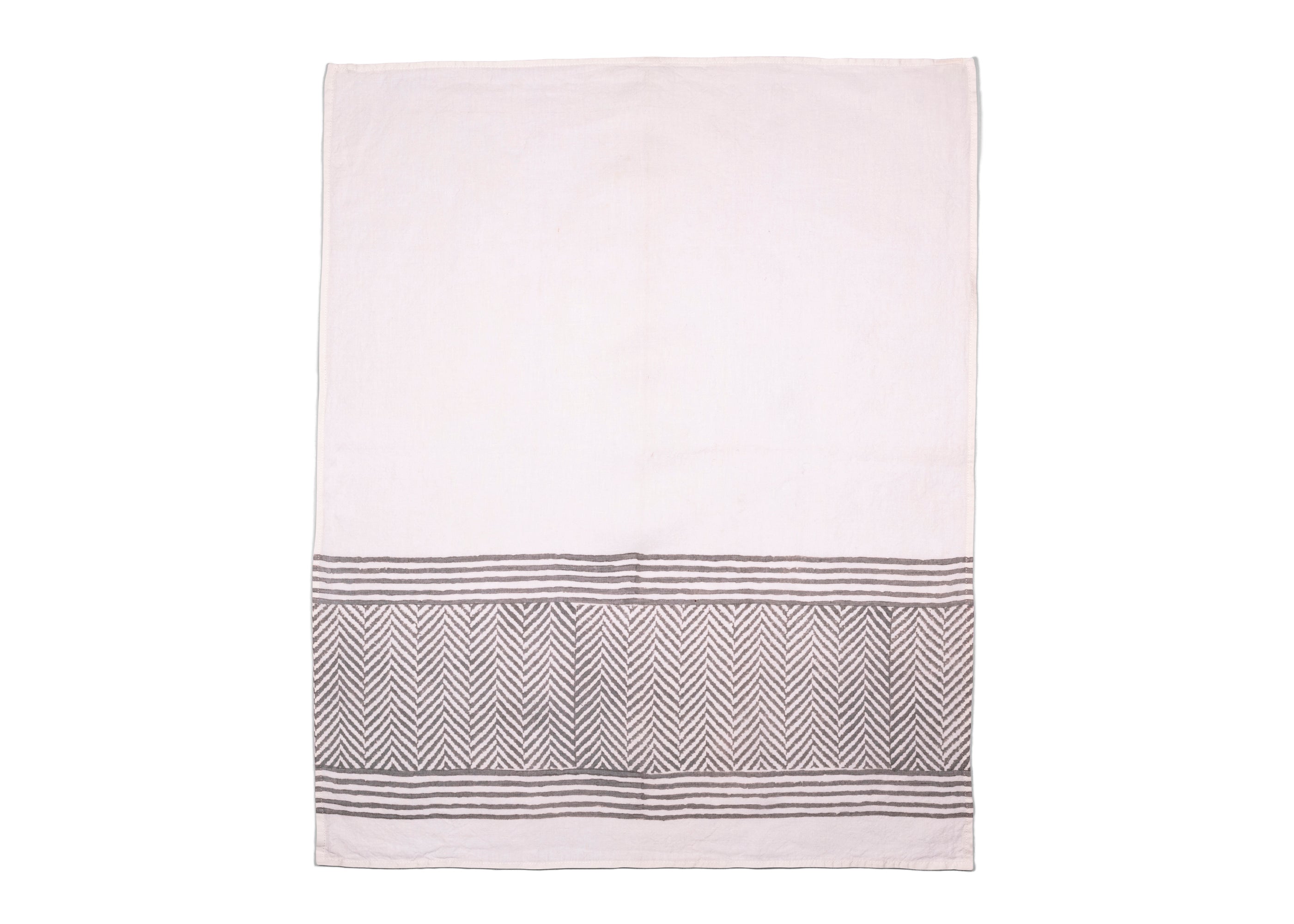 Unfolded tea towel revealing white base and soft grey chevron pattern, making any table or kitchen look cozy and comfortable.