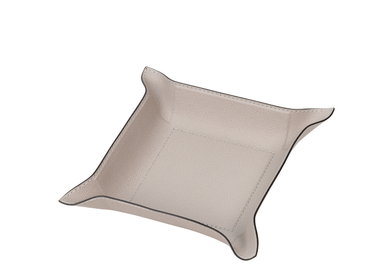 This exceptional stone beige square tray has the hard base and flexible sides that can be adapted to your preferred arrangement, and covered in the finest calfskin makes a both functional and decorative piece for any space at home.